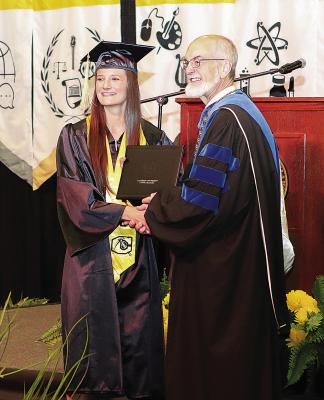 Cameron University President John McArthur congratulates Korie Allensworth of Fort Towson, who earned a Bachelor of Science degree in Sports and Exercise Science.