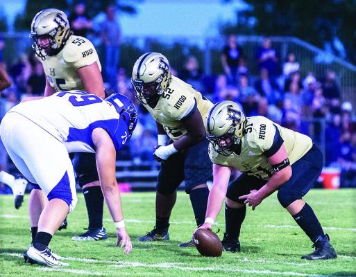 BUFFALO CENTER JAYCE TRANTHAM sets up over the football, flanked by guard Kory Mitchell and tackle Noah Joe on the right side of the Buffalo line. The trio moved Wilburton Diggers all night long contributing to a massive 62-0 Buffalo Homecoming victory. Hugo News Photo / Bobby Hamill