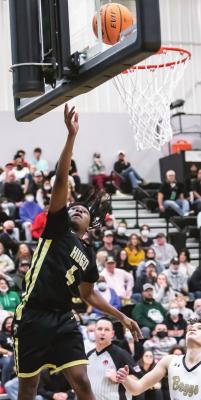 NMI _ KEION JOHNSON picks up two points for the buffaloes against Beggs in the Area Tournament Finals Friday in Henryetta. The Buffs fell to the Demons, but defeated Keys to earn another berth in the State Basketball Tournament.
