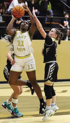 KE’SHAWNA SCROGGINS steps between Broken Bow defenders to put up two points for the Hugo Lady Buffaloes in recent basketball action in Hugo. Hugo News Photo / Kelli Stacy