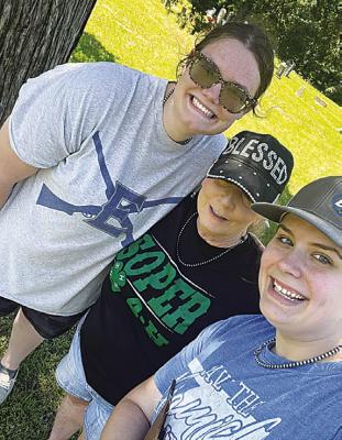4-H Member Kate Clifton, Soper Leader Shelly Moffatt and Kallie Clifton pose at the Sugar Creek Cemetery during American ag decorating. Kallie started this project in 2018 as her State 4-H Ambassador project.
