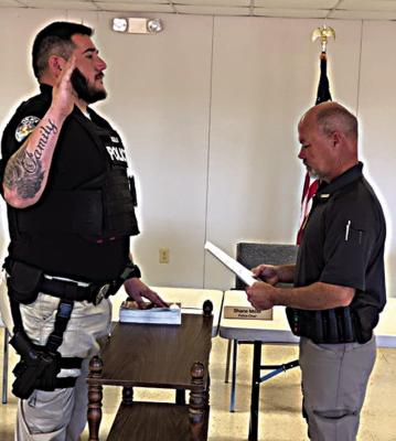 Brock Aguilar (left) has been hired as a part time officer for the Sawyer Police Department and was sworn in under oath at a recent meeting of the Board of Trustees. The Oath of Office was administered by Chief Shane Miller.
