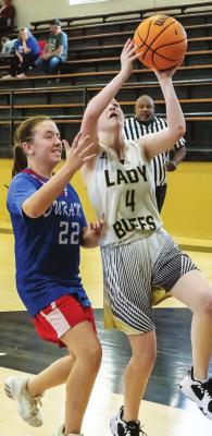 HUGO LADY BUFFALOES JV teams battled the Durant Lady Lions last week in Hugo basketball action, posting a 38-16 win. Above, Kacyn Beard puts up two points for Hugo as does her teammate, Calista Kelley in the photo at right. Hugo News Photo / Bobby Hamill