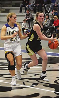 ABBY HIGGINBOTTOM takes the ball into the paint for a shot against Stringtown in the Tigers’ recent District win.