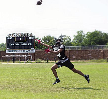 REACHING FOR THE LONG BALL during Hugo Buffalo spring football drills last week on Buff Parker Field was wide receiver K.D. Jones. Jones, a freshman, will be battling for a starting position and more game time when the Buffaloes begin their fall schedule in September. Hugo News Photo / Kelli Stacy