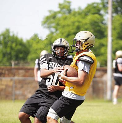 ISAIAH GREER makes contact with Hugo Buffalo Quarterback Jayka Santillan during spring training drills on Buff Parker Field in Hugo last week. The Buffaloes will be young but quick in their defensive program next fall. Hugo News Photo / Kelli Stacy