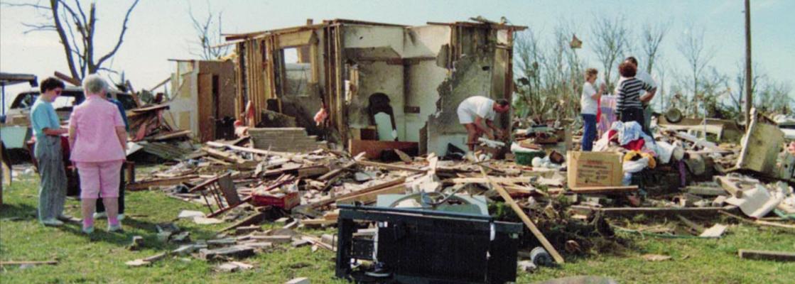 Friends help a family shift through the debris after an April 26, 1991 tornado hit Oologah, Okla. ©1991 and 2021 photo by Millie Moseley, Oologah Lake Leader