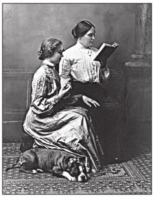 left:Anne Sullivan (right) reads to Helen Keller whose June 27 birthday is celebrated during Deaf-Blind Awareness Week during the last week of June each year.