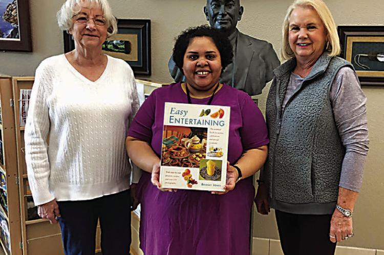 Iris Garden Club presented a book to the Choctaw County Library, as one of their yearly projects. Pictured are Donna Colgin (left) and Harolynn Wofford (right) with librarian Bessie Black (center).