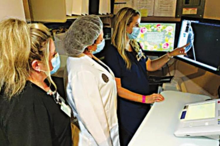 Mammogram Technologist Ashley Kennedy, R.T. (R)(CT)(M) B.S., shows Dr. Chisum-Price and Radiology Physician Assistant Ami Hess the Magseed on the image of the breast.