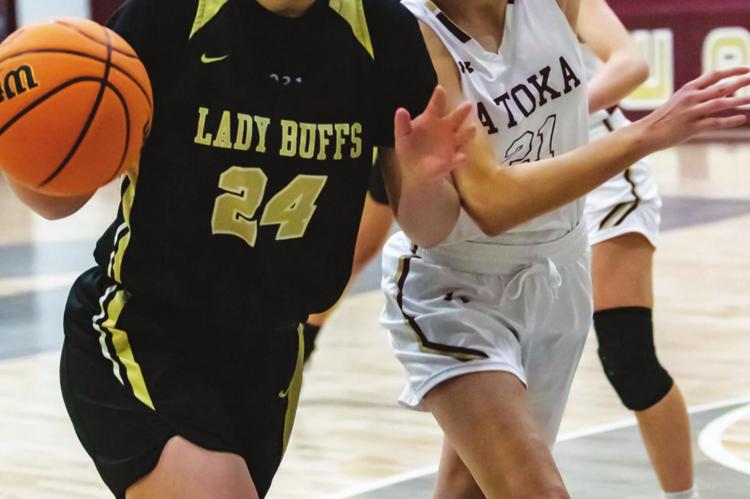 BRINLEE ALLENSWORTH pushes the basketball into the paint and draws a foul for the Hugo Lady Buffaloes in their Regional Tournament game against the Atoka Wampus Cats.