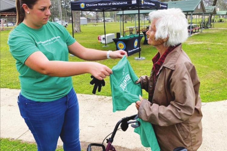 SAMANTHA J. SNEAD presents “Granny” Miller with a t-shirt for her continued efforts of trash pickup in Valliant. Known as the “Town Granny,” Miller turned 93 on April 15. Photo Courtesy / Charles Clark, Choctaw Nation