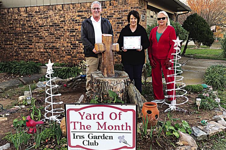 Iris garden club Yard of the Month for December is Terry and Debbie Park in Jay Mac Addition. Chosen for their beautiful Christmas lights and decorations, they maintain their property beautifully all the time. Pictured are the Parks and club President Harolynn Wofford.