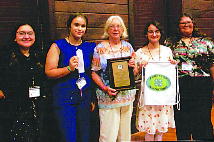 Above: 4-H National Forestry Judging Contest Tommy and Susan Futral Inspiration of the Invitational Award fourth place team: Stacey Scott, 14th overall individual; McKayla Brents, third overall individual, third pulpwood toss, fourth crosscut sawing; Alicia Brents, 4-H Forestry coach; Samantha Scott, eighth overall individual; Autumn Diggs, fourth crosscut sawing. 