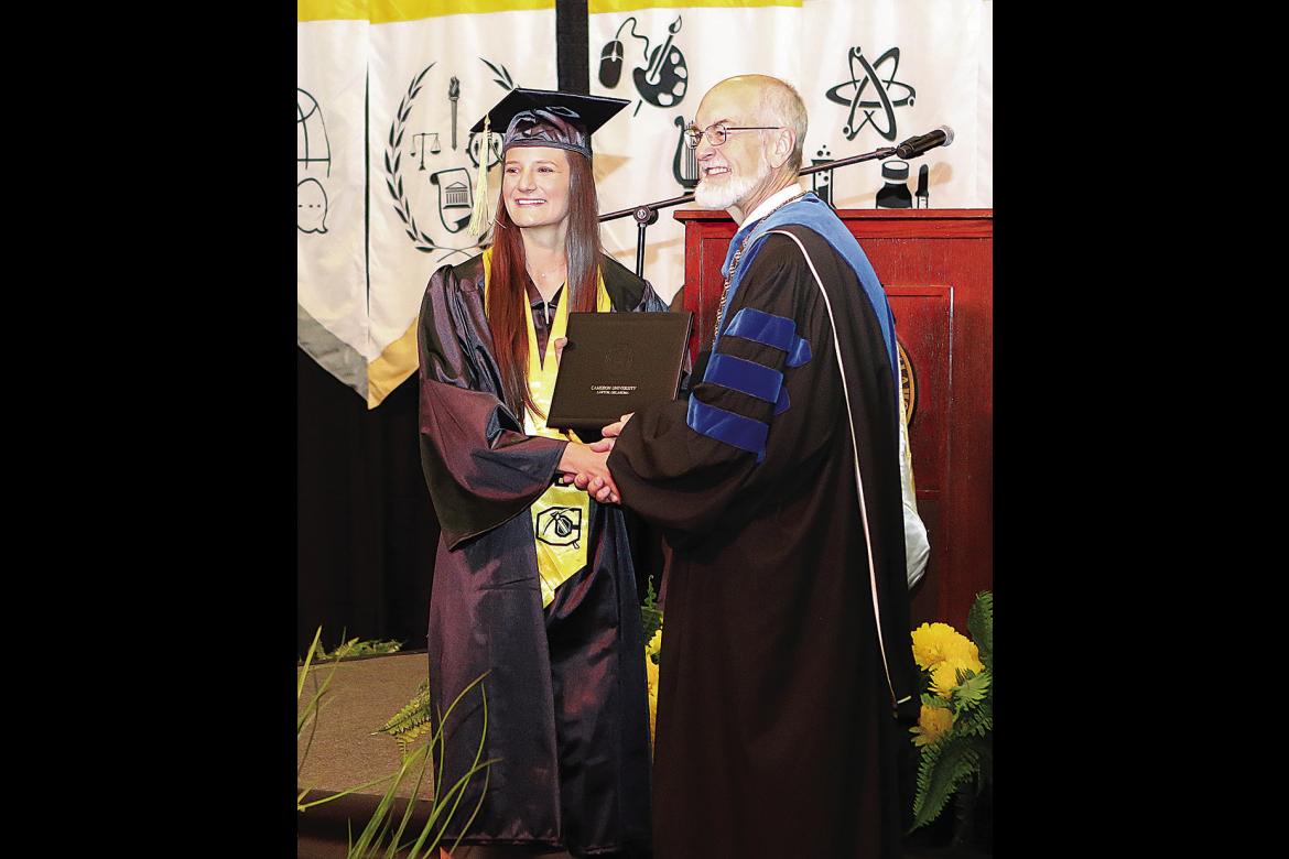 Cameron University President John McArthur congratulates Korie Allensworth of Fort Towson, who earned a Bachelor of Science degree in Sports and Exercise Science.